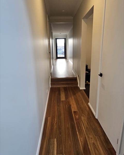 A freshly painted interior hallway with timber floors