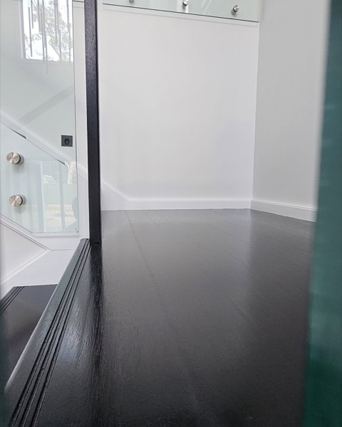A freshly painted interior with a glass balustrade