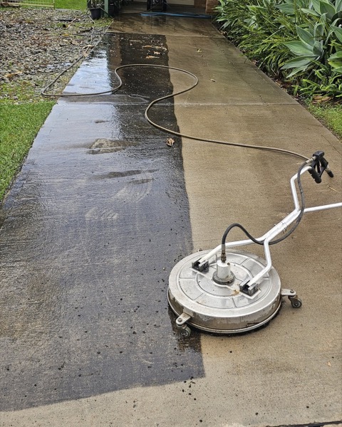 A driveway being pressure cleaned with a surface cleaner
