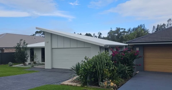 A repainted home exterior with a tidy front garden