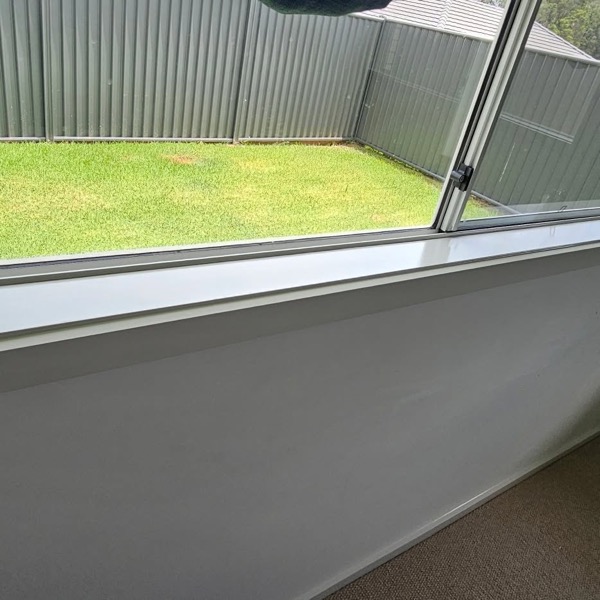 A painted fence and freshly finished eaves