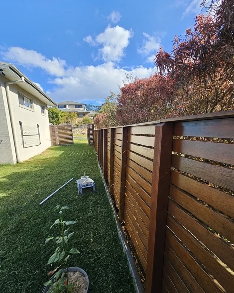 A timber fence freshly stained
