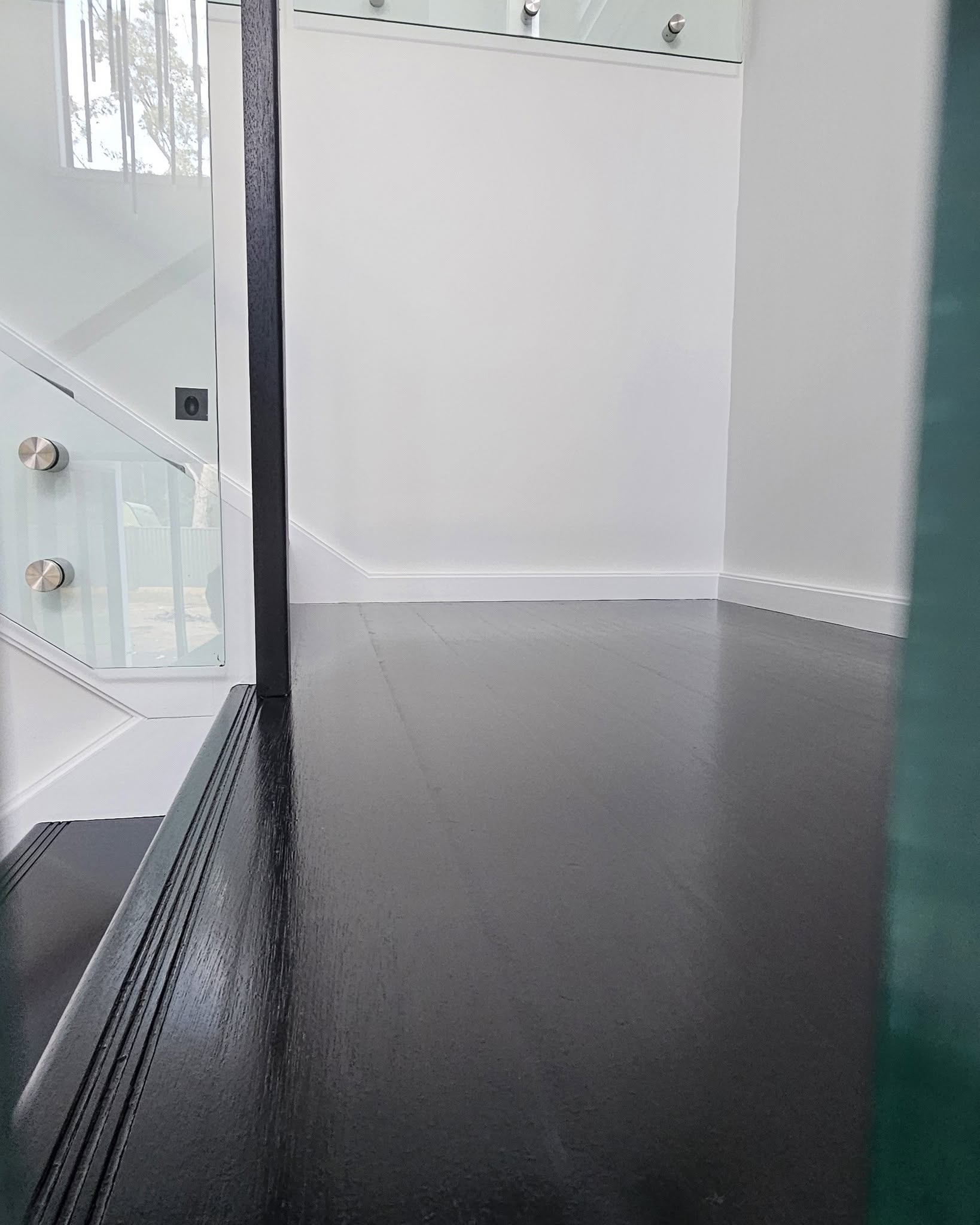 A freshly painted interior with a glass balustrade
